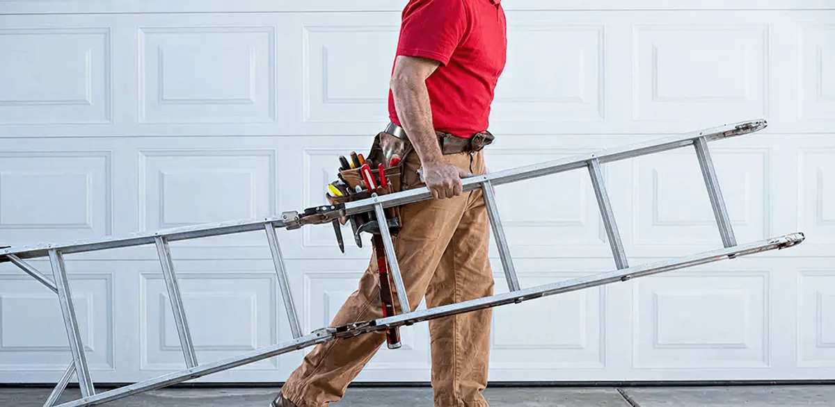 Garage door repair technician arriving with tools and ladder in Chicago, IL