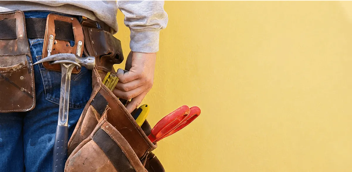 Handyman with tool belt ready for home repairs and maintenance in Chicago, IL